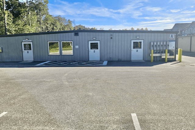 Outdoor view of climate-controlled units at Space Savers Storage in Mobile, AL, with protection plans for secure moving and relocation storage.